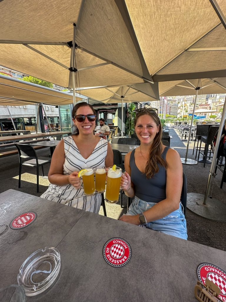 Stephanie & Sara drinking beers at La Brasserie de Monaco