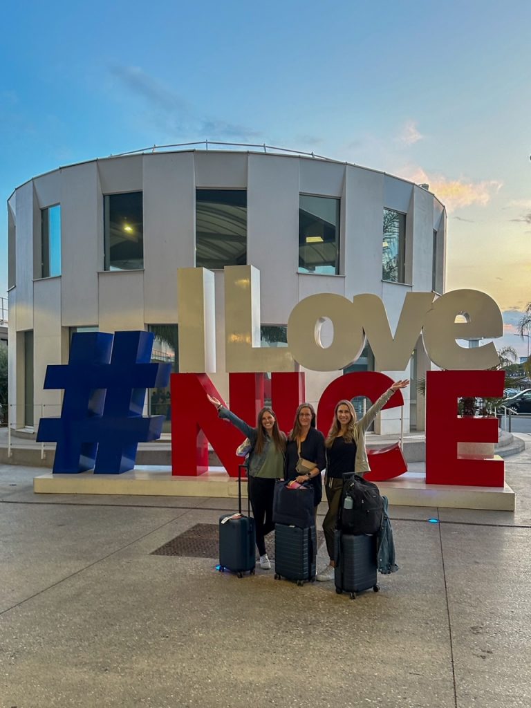 the girls excited to arrive in Nice and posing in front of the #ILoveNice sign