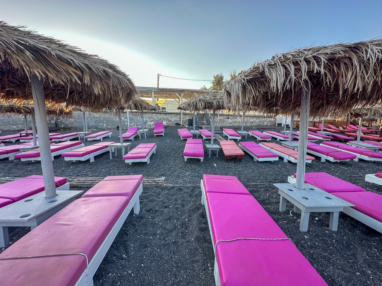 chairs & umbrellas at Perissa Beach, a must-see area on the island of Santorini