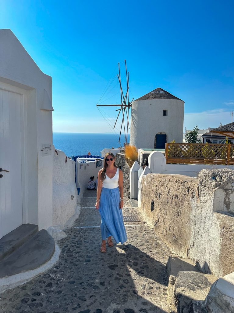 Sara in front of one of Santorini's iconic windmills