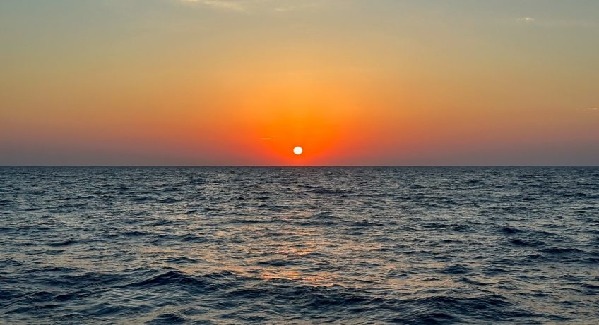 a beautiful sunset from our Santorini catamaran cruise