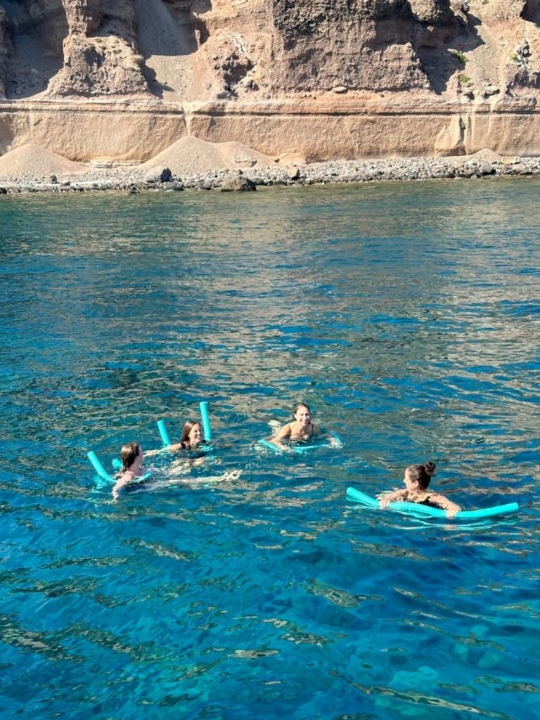 the girls swimming on their Santorini catamaran cruise