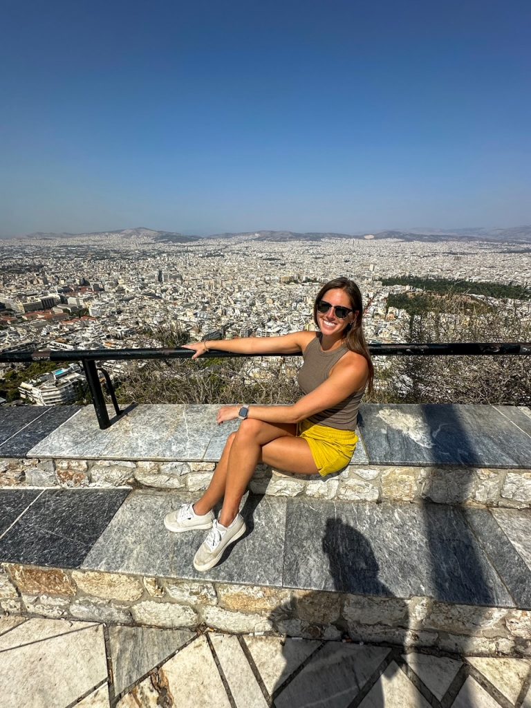 Sara with a gorgeous backdrop at Lycabettus Hill, a must-see during your 3 days in Athens