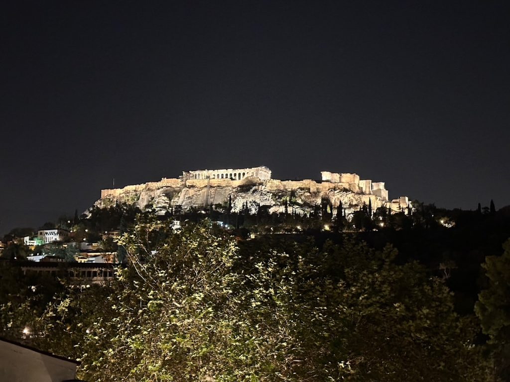 a nighttime view of the Acropolis from the rooftop at Kuzina