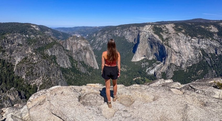 Sara admiring the panoramic view of El Capitan and Yosemite Valley from Taft Point in Yosemite