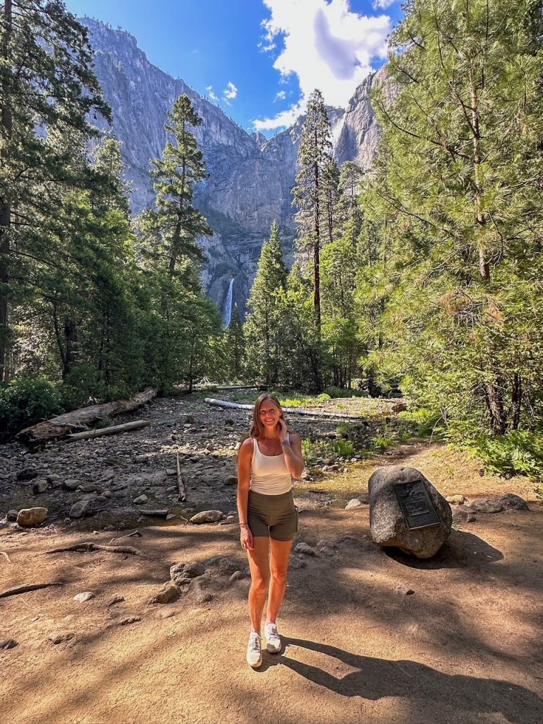 Sara posing in front of Yosemite Falls at the Lower Yosemite Fall Viewpoint