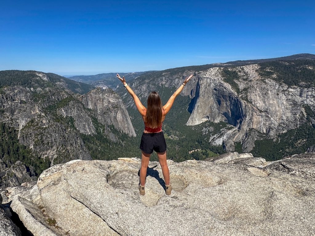 Sara presenting El Capitan and Yosemite Valley from Taft Point, an easy to moderate hike in Yosemite