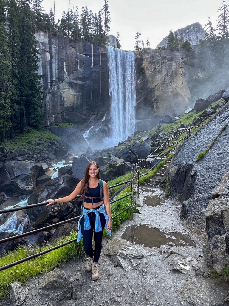 Sara standing on the granite steps in front of Vernal Fall, the first stop on the most epic hike in Yosemite