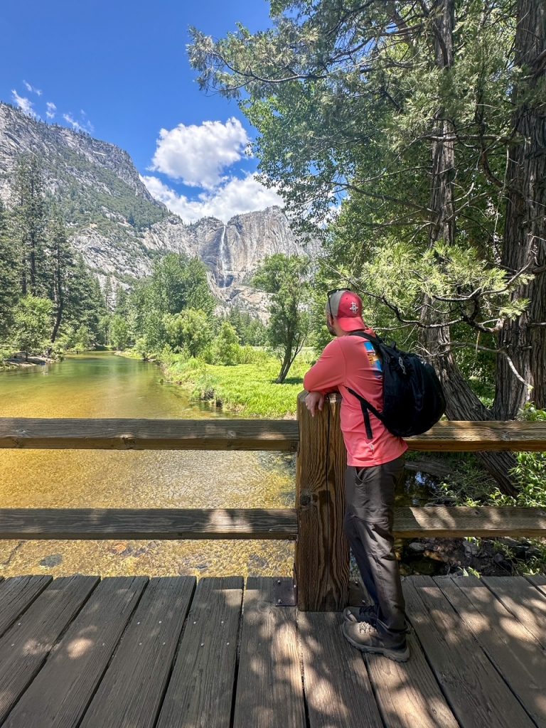 Tim admiring Yosemite Falls from Swinging Bridge on the second day of our Yosemite itinerary