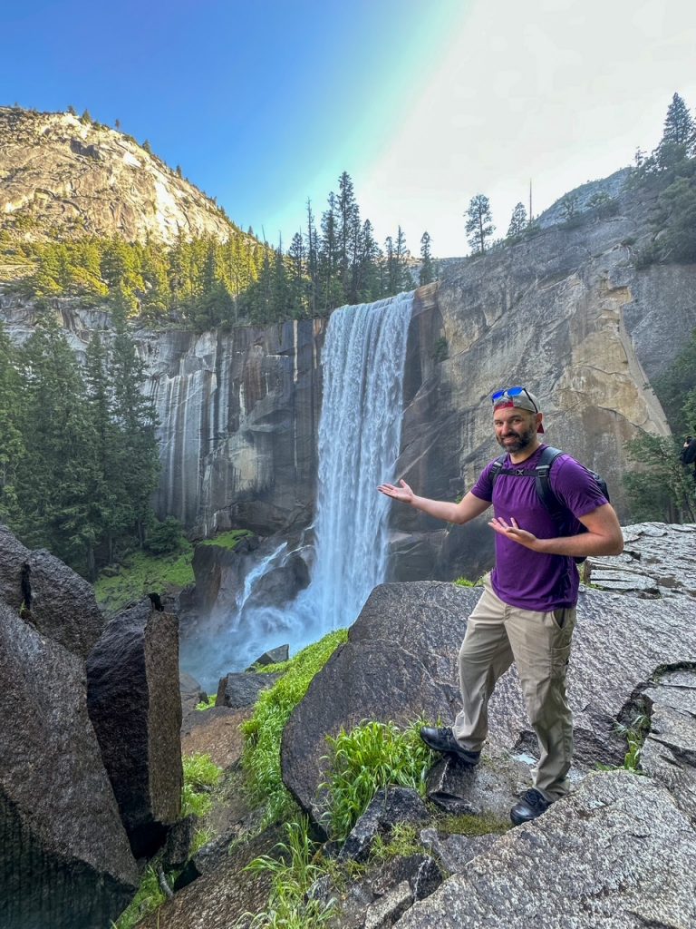 Tim pointing at the incredible Vernal Fall in Yosemite flowing wildly in June