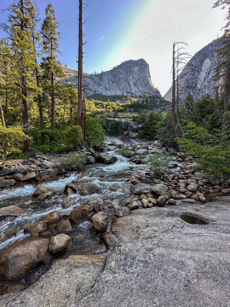 a beautiful mountain and rocky river view flowing into Vernal Fall in Yosemite