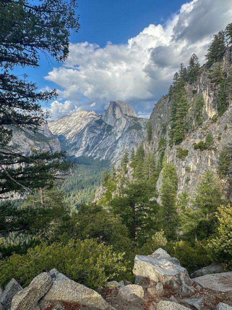 a stunning view of Half Dome in the afternoon light from the Four Mile Trail in Yosemite