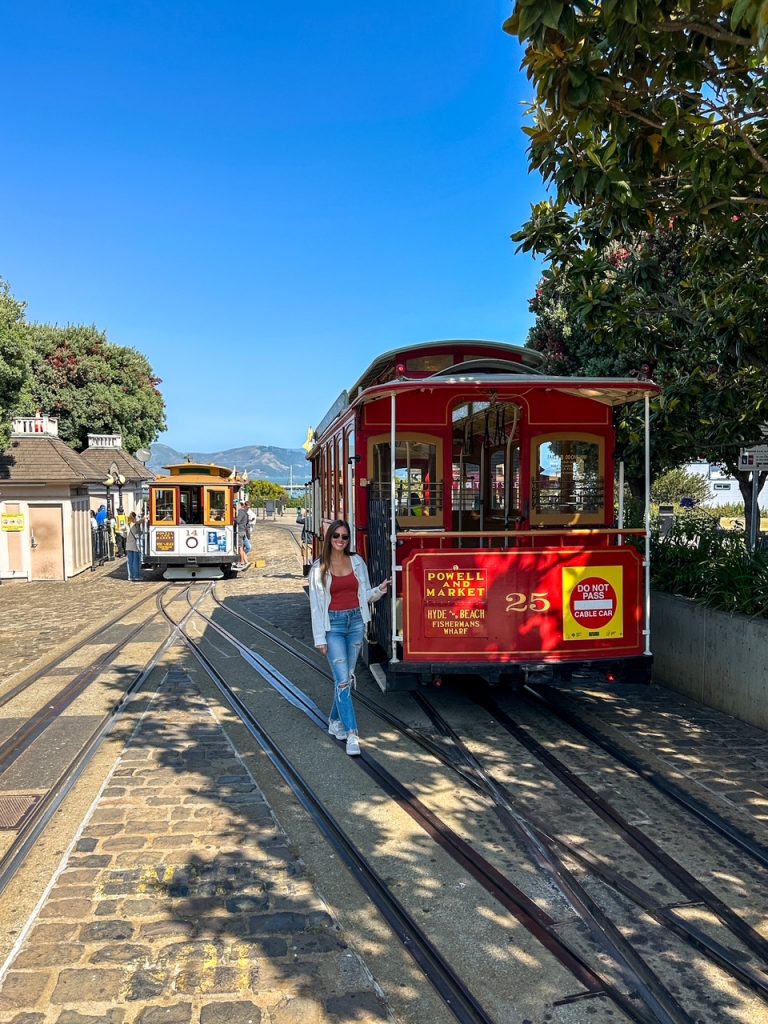 Sara with one of the historic cable cars at Fisherman's Wharf in San Francisco