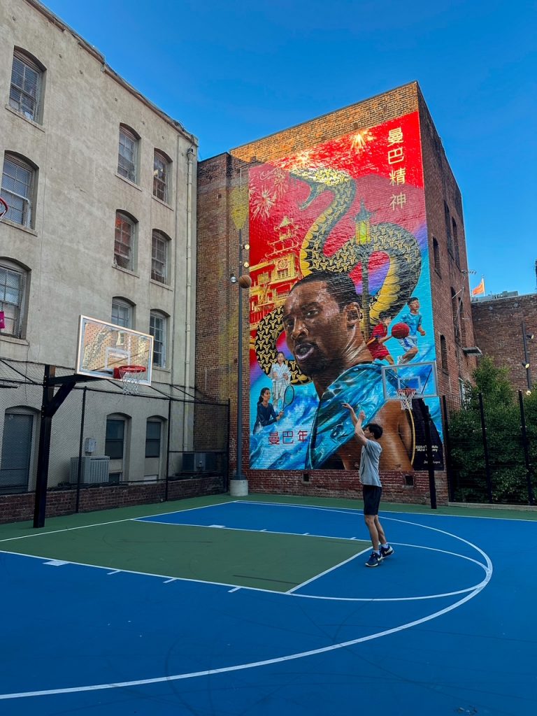 a jump shot in front of the Kobe Bryant mural in Chinatown in San Francisco