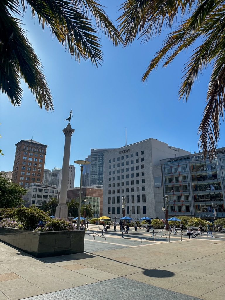 a view of Union Square from behind some trees in San Francisco