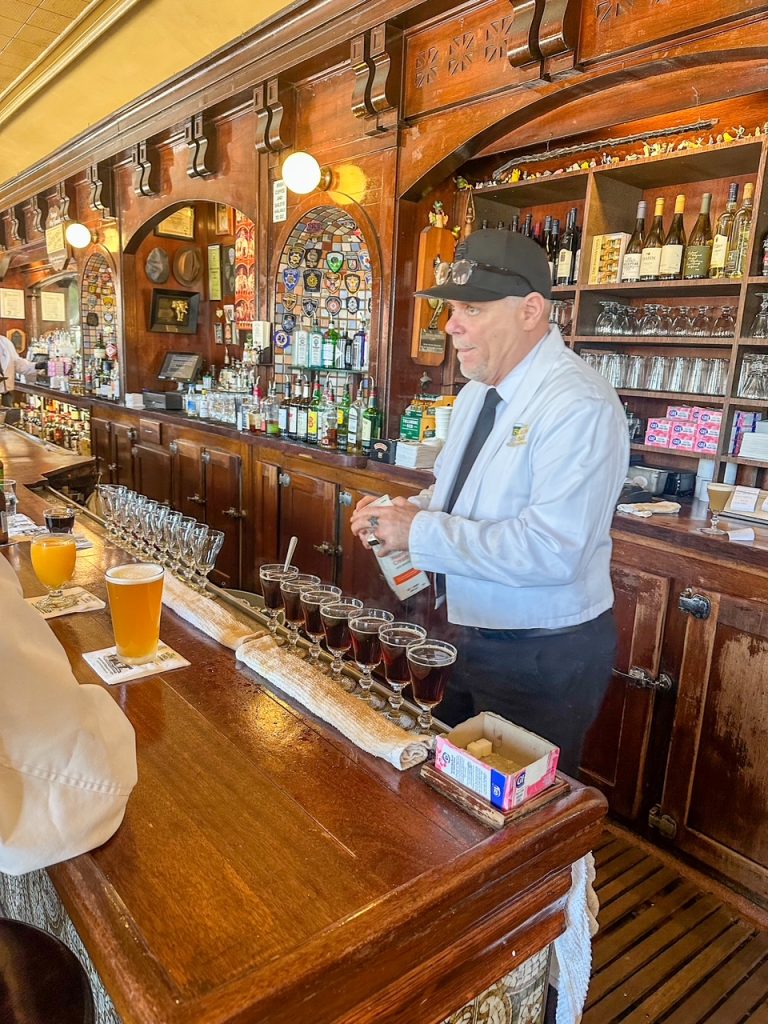 one of the bartenders lining up Irish coffees at the bar at The Buena Vista in San Francisco