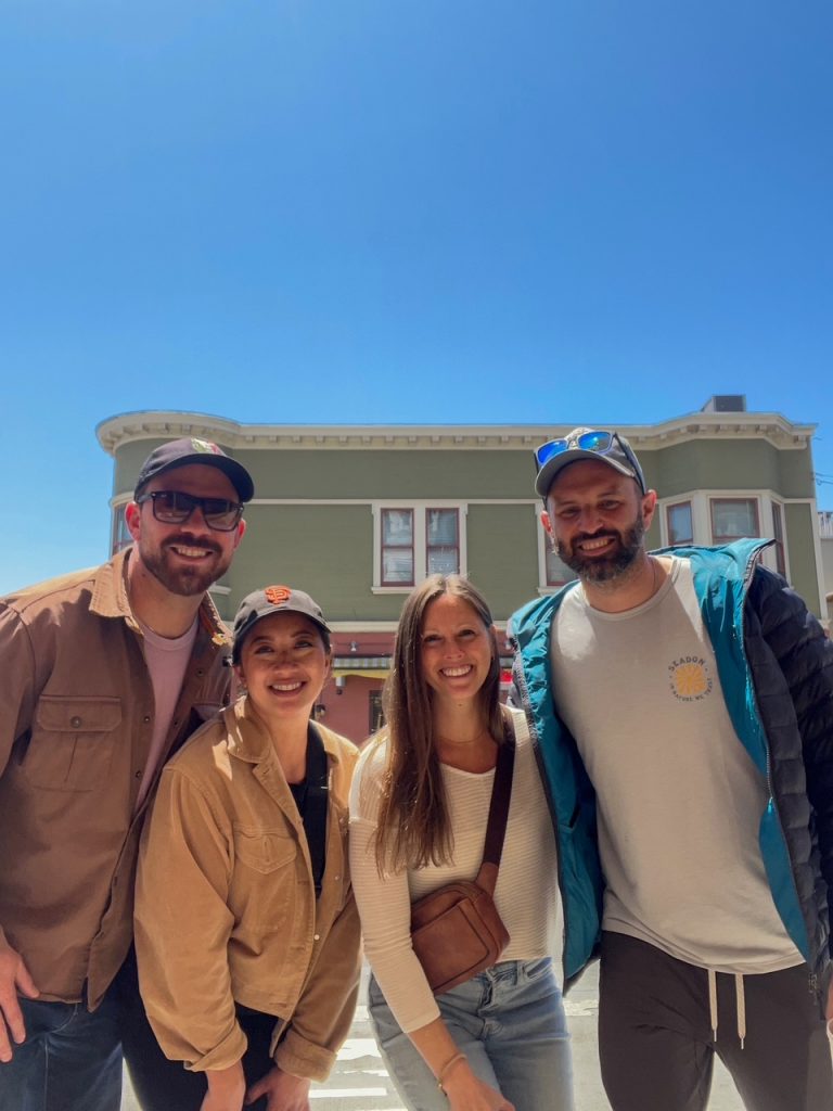 Friends posing in front of The New Spot on Polk restaurant in San Francisco before driving to Yosemite