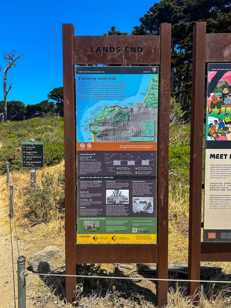 Lands End trailhead sign and map at the start of the coastal trail