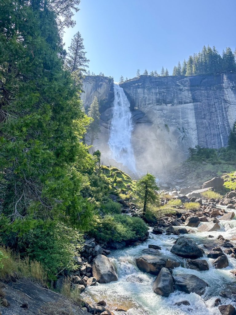 Nevada Fall surrounded by pine trees in Yosemite National Park on a sunny June day