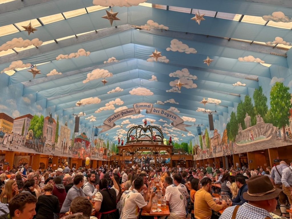Blue sky-painted ceilings with fluffy white clouds at Hacker-Pschorr Festzelt in Munich
