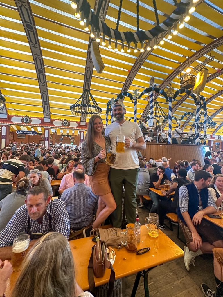 Sara and Tim dancing on a table at Oktoberfest in Munich