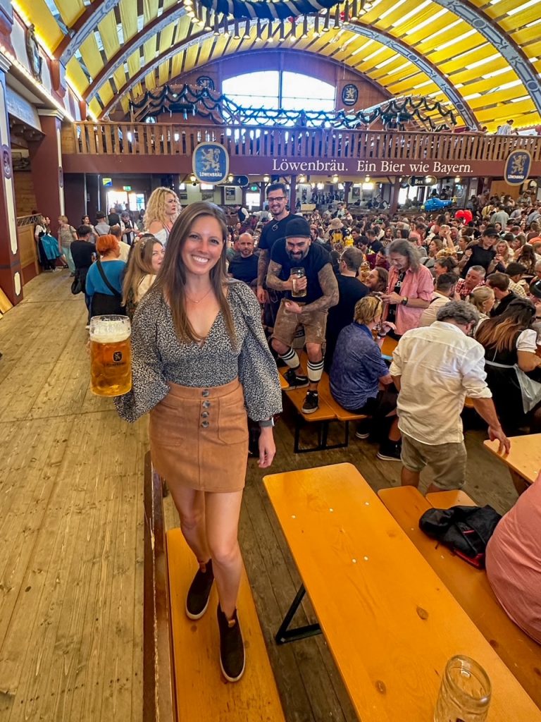 Sara standing on the table dancing at Lowenbrau-Festzelt at Oktoberfest in Munich