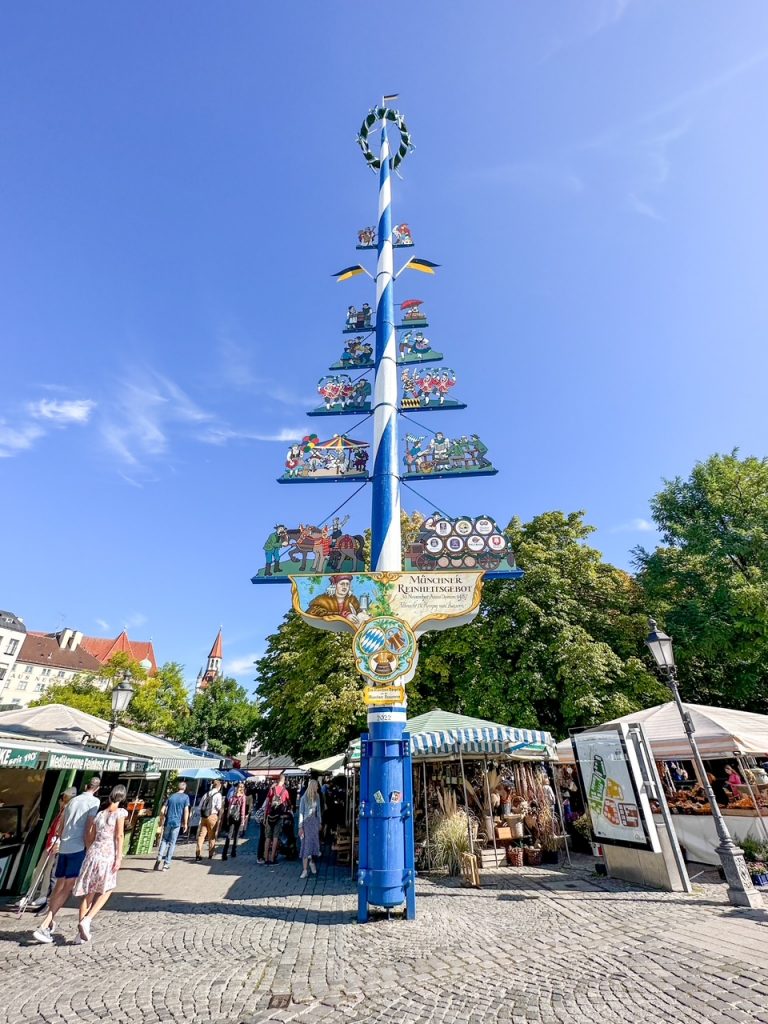 Traditional Maypole decorated with flags in Munich