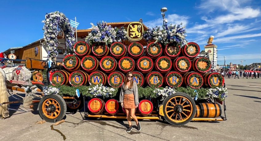 Sara in front of a Lowenbrau keg cart at Oktoberfest in Munich
