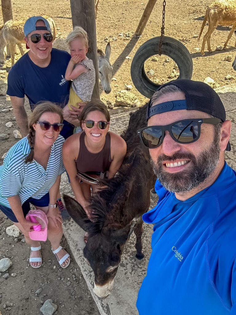 Group with a donkey at the Donkey Sanctuary Bonaire