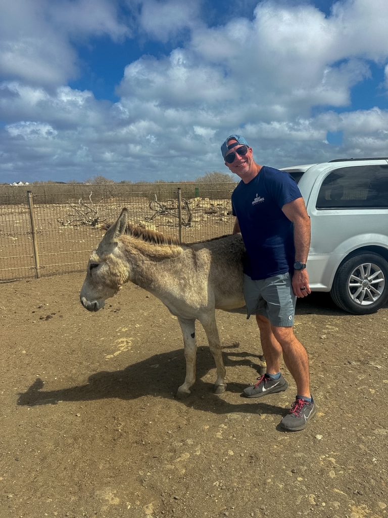 John with a donkey at the Donkey Sanctuary Bonaire