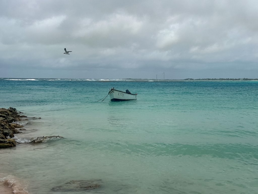 boat sitting in the clear turquoise water in Lac Bay Bonaire