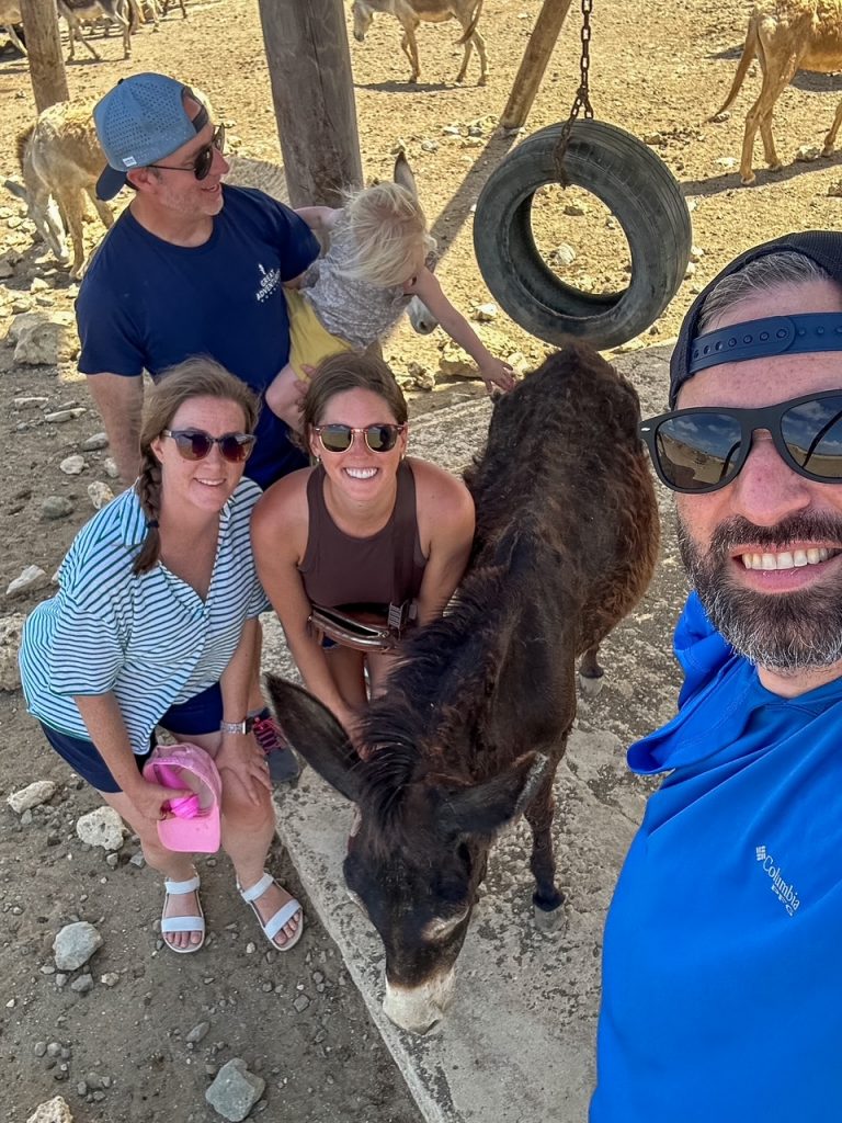 group with a donkey at the Donkey Sanctuary in Bonaire