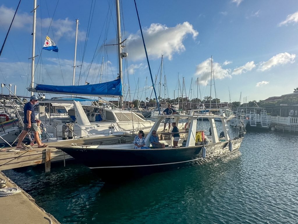 Guests boarding the Sushi Sunset Boat Tour at Harbour Village Marina in Bonaire