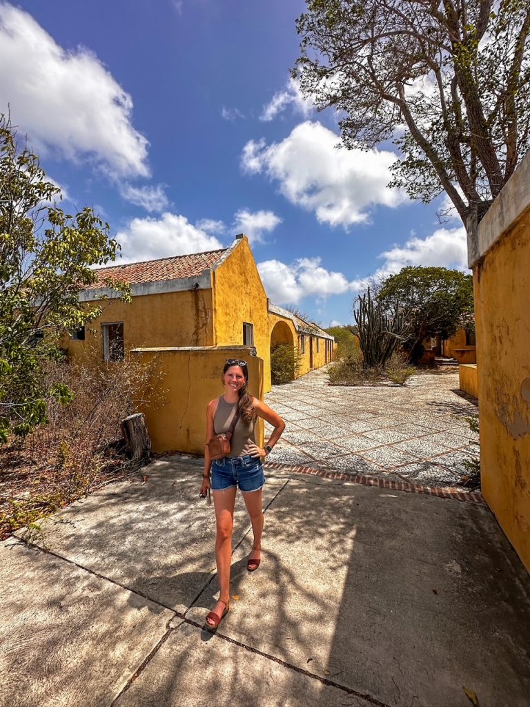 Sara standing in front of Karpata Plantation in Bonaire